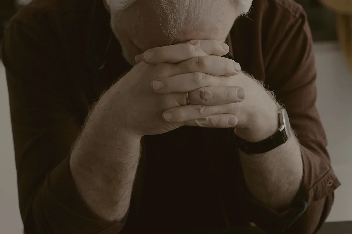 Hands turning the pages of a photo album.