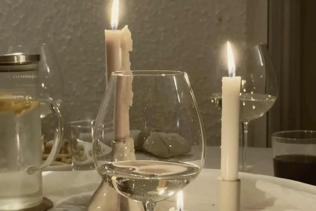 A table after dinner, plates pushed aside, conversation still going.