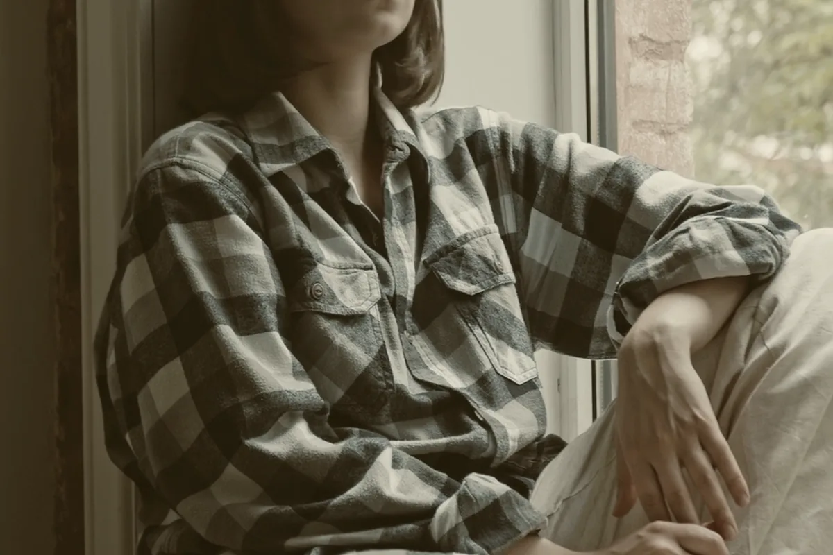 Someone looking out of a window, lost in thought.