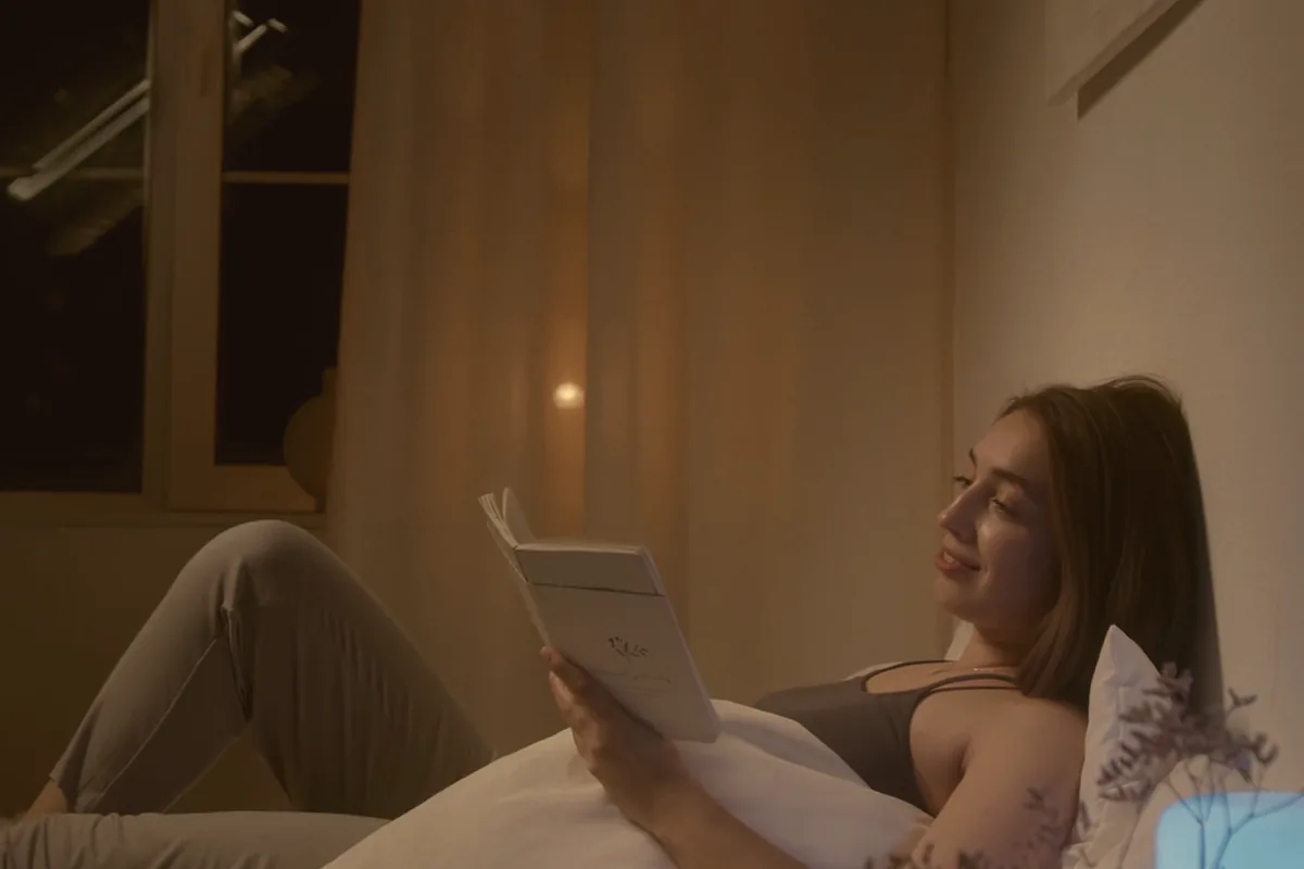 Someone reading, hands holding an open book.